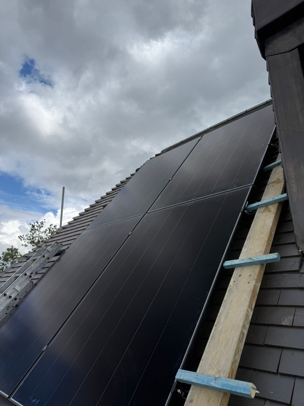 Solar panels secured to roof battens during installation