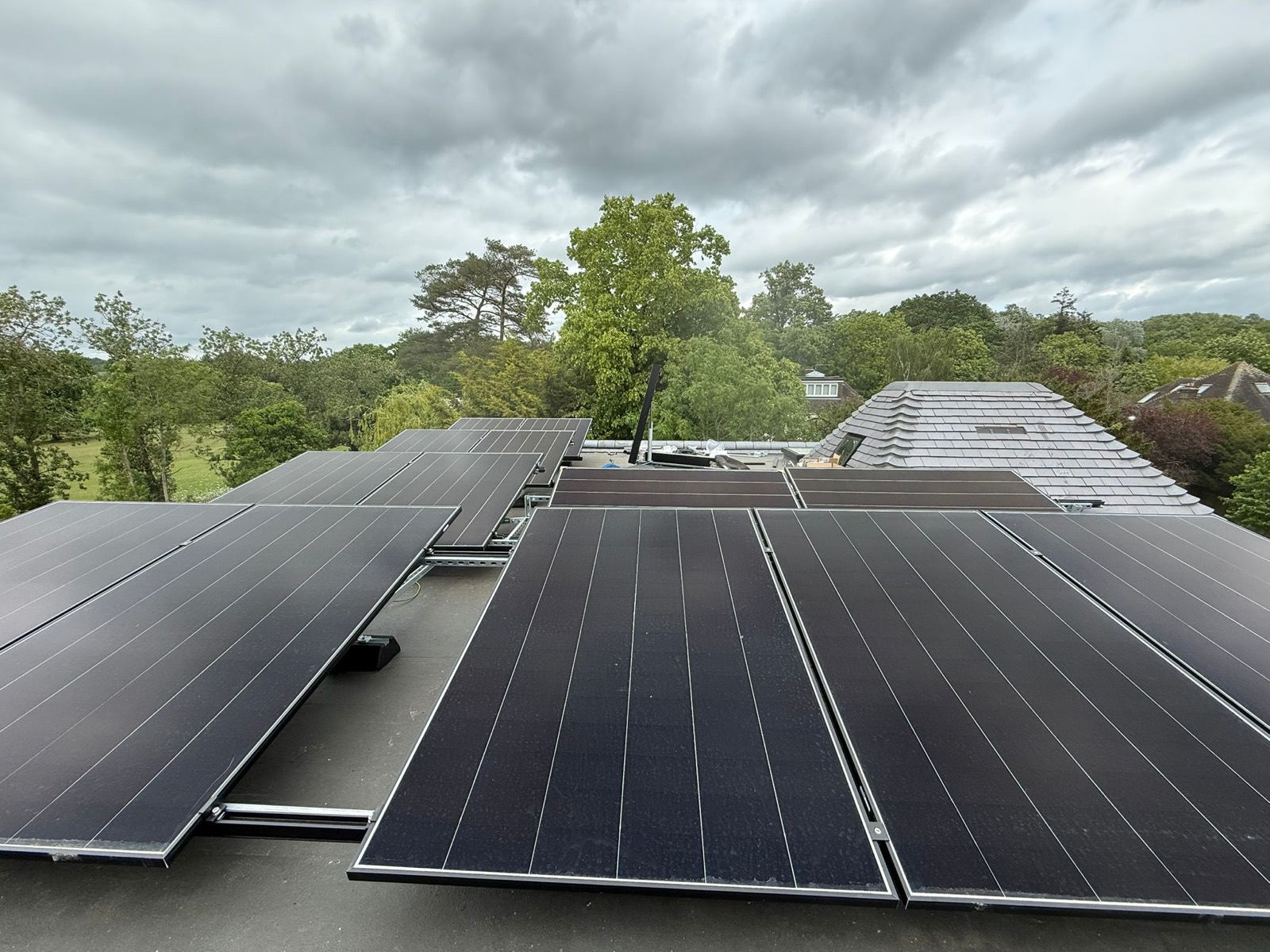 Wide view of a completed rooftop solar array under an open sky