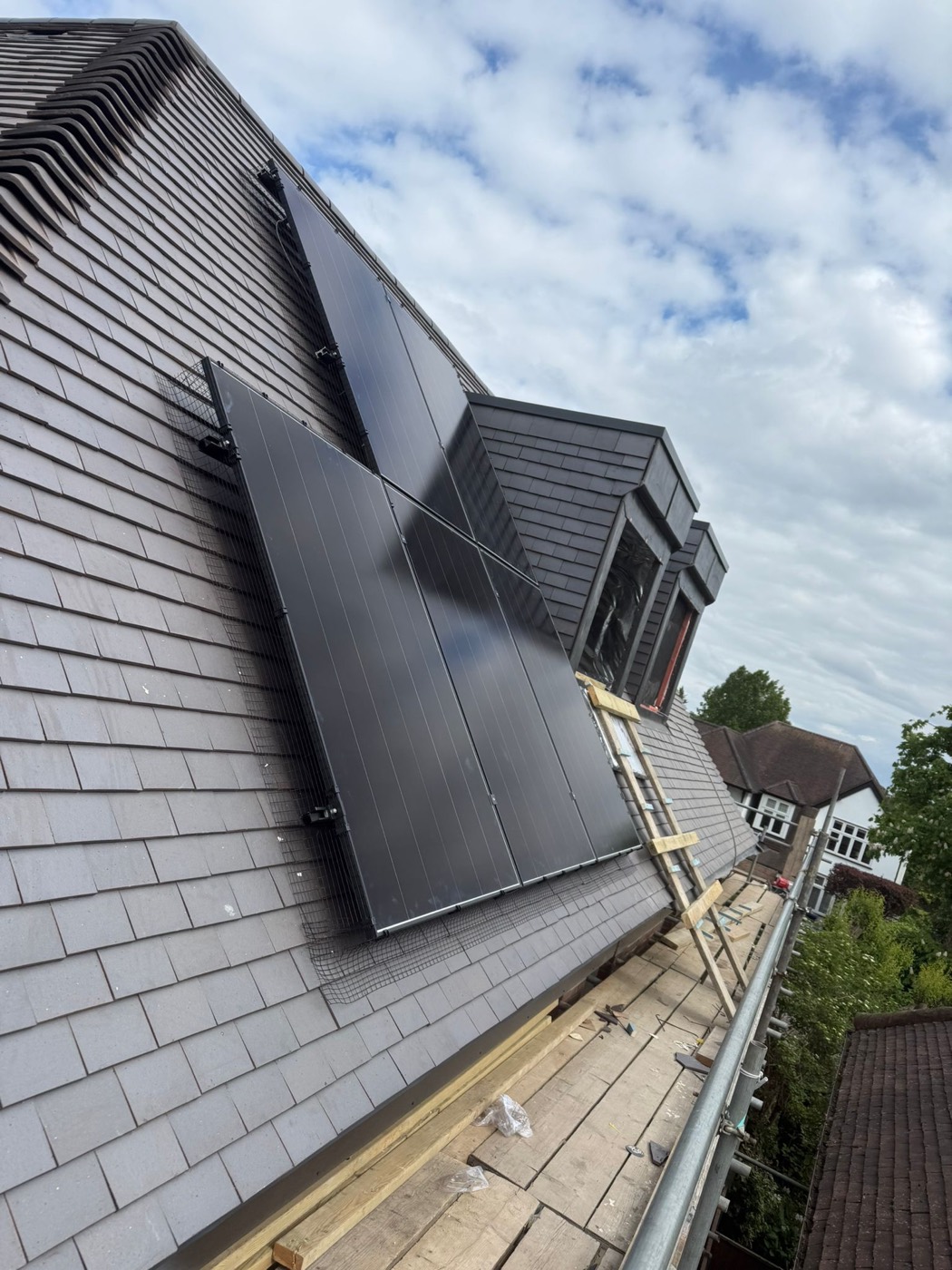 All-black panels mounted on a slate-grey pitched roof